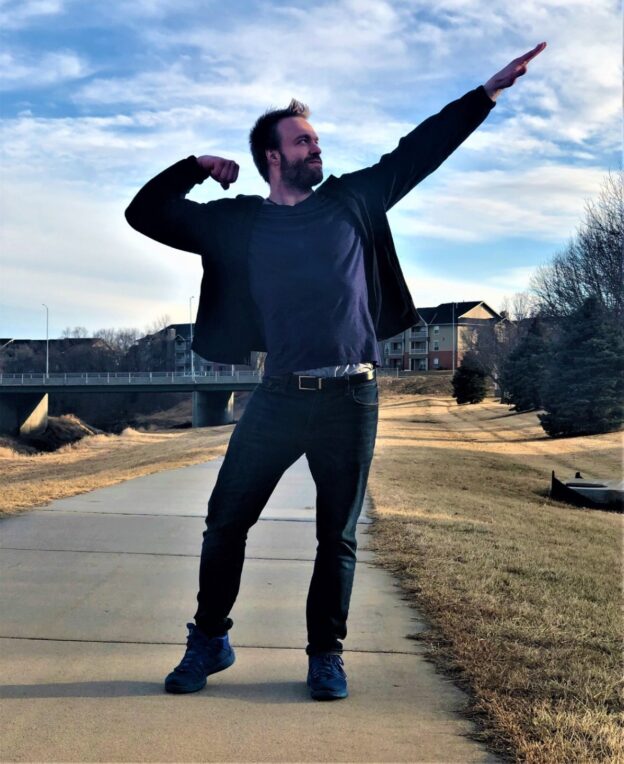 picture of bestpersonaldevelopmentcourses.com's transformation coach striking an inspiring flexing pose on a trail outdoors